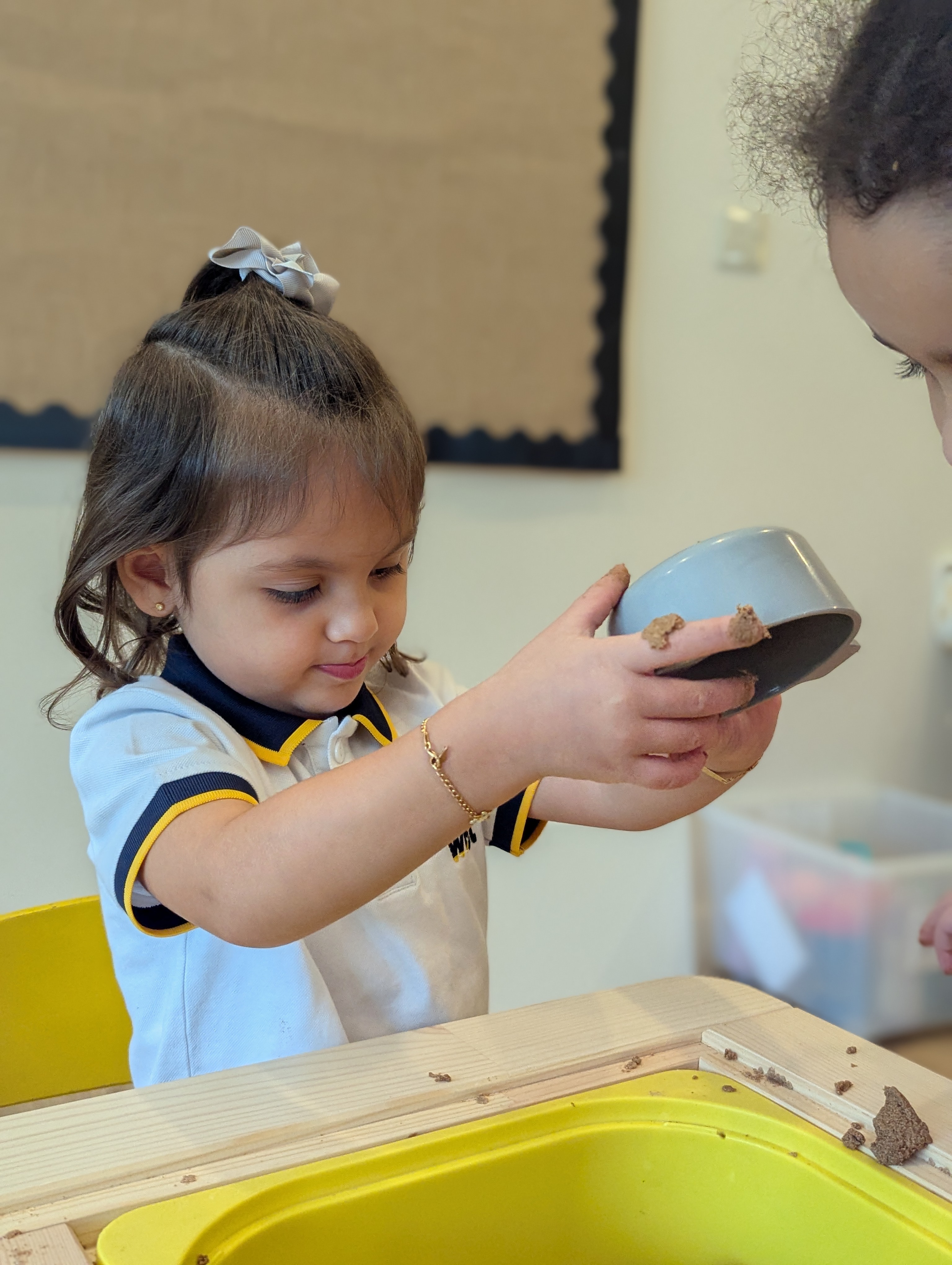 Children playing and exploring in class